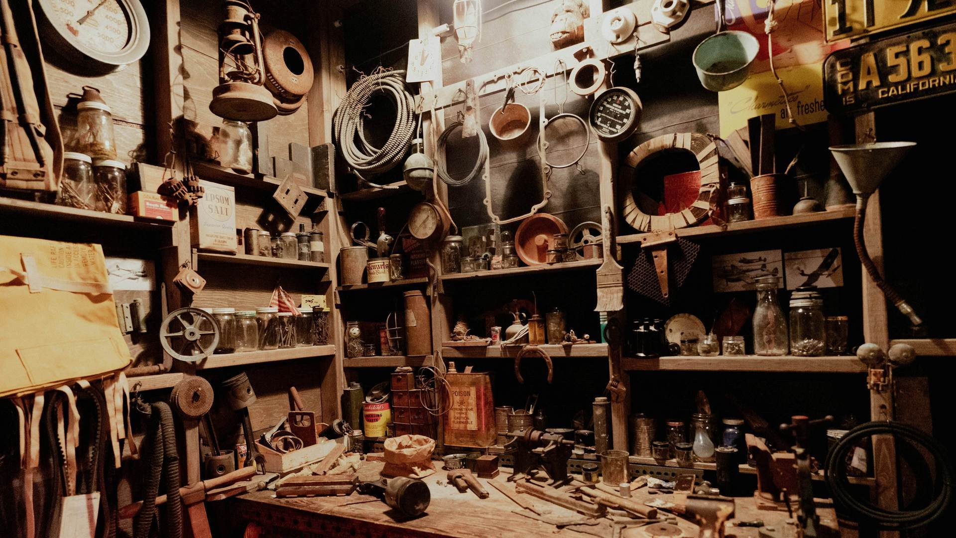 A workshop wall crowded with hand tools and jars of parts