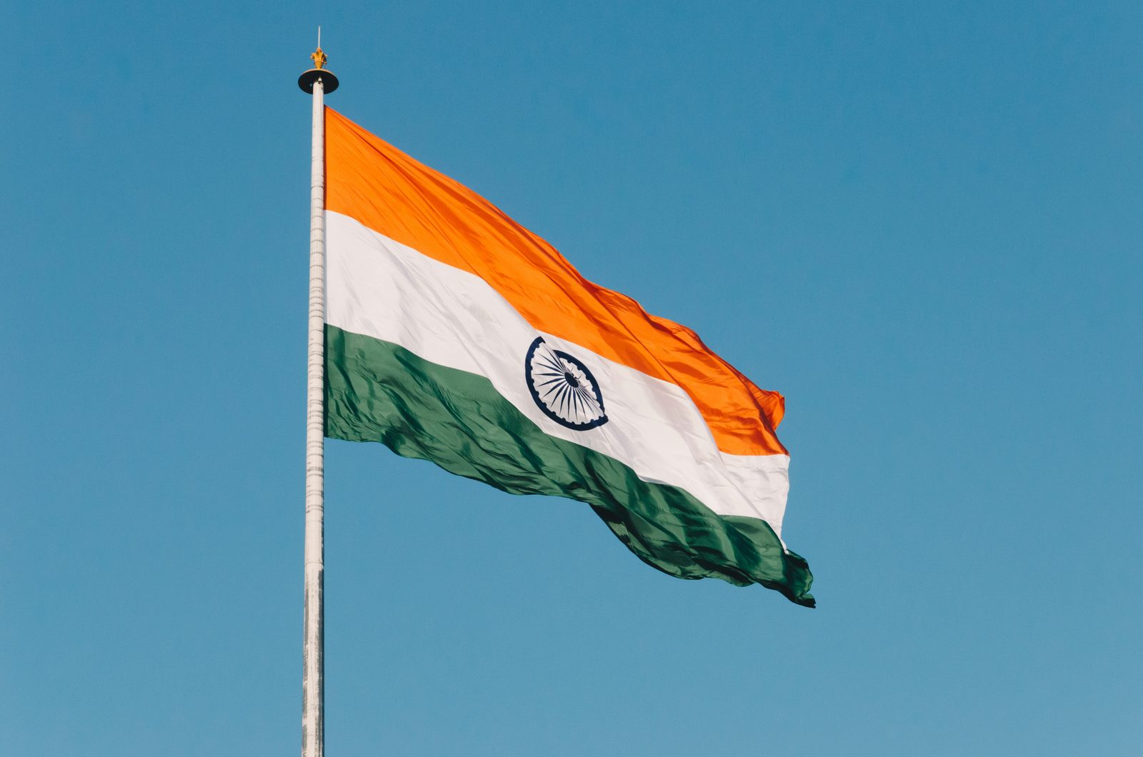 The Indian flag flying against a clear blue sky